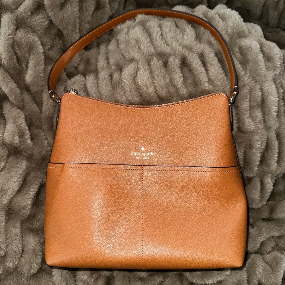 Kate Spade bucket purse with 2 front pockets. Tan leather. New W/O tags